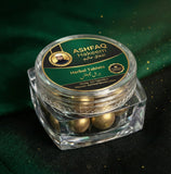 ASHFAQ Hakeem herbal tablets in a clear jar with gold label, on green fabric background